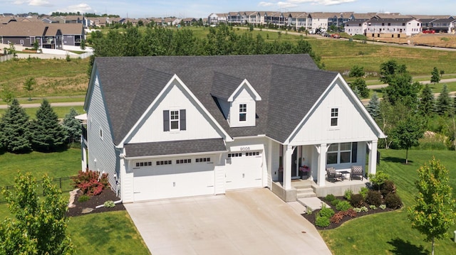 view of front of home featuring a porch and a garage