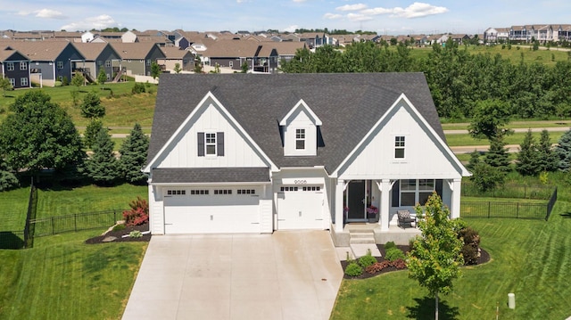 view of front of home with a garage, a front lawn, and covered porch