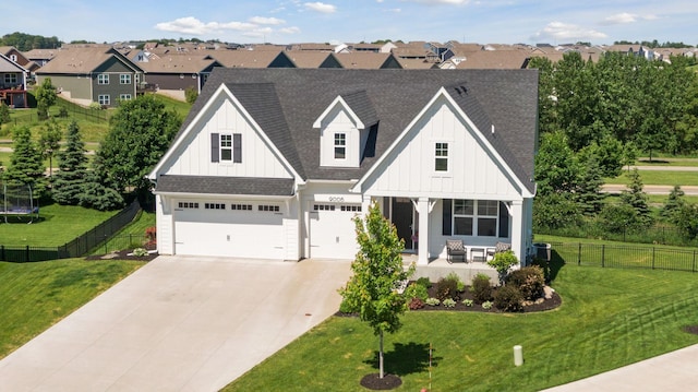 view of front of property featuring a garage, a front lawn, and a porch