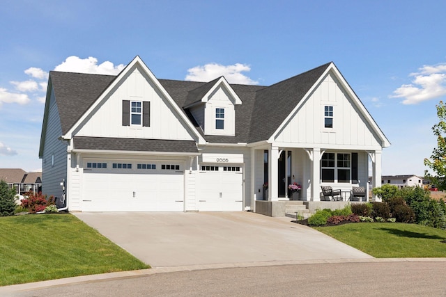 view of front facade featuring a garage, a front lawn, and a porch