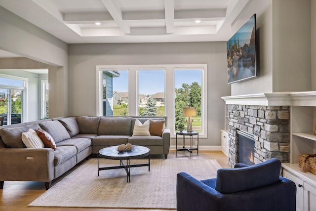 living room with a fireplace, coffered ceiling, light wood-type flooring, and beamed ceiling