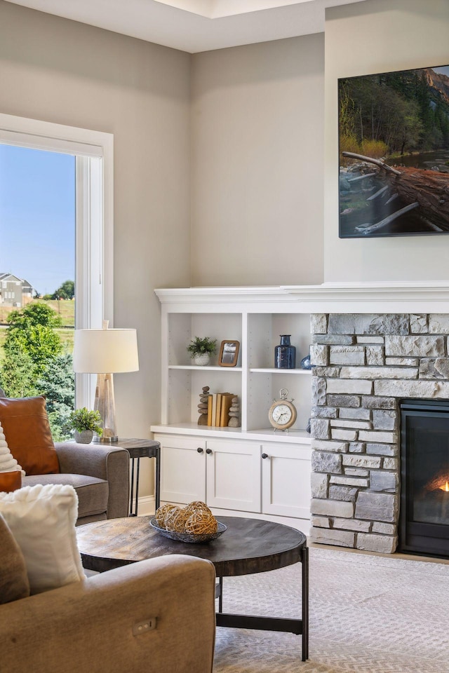 sitting room with a stone fireplace