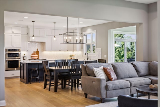 living room with light hardwood / wood-style flooring