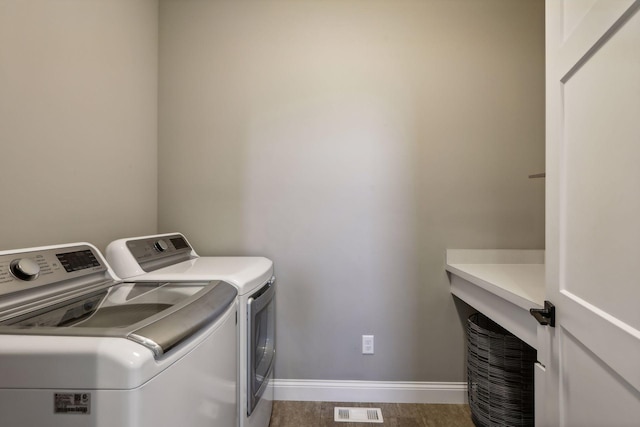 clothes washing area featuring washer and clothes dryer