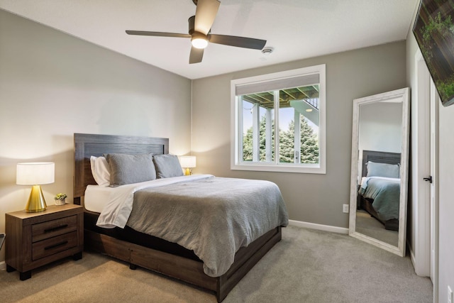 bedroom with ceiling fan and light carpet