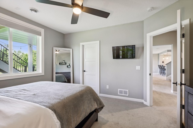 bedroom featuring ceiling fan and light colored carpet