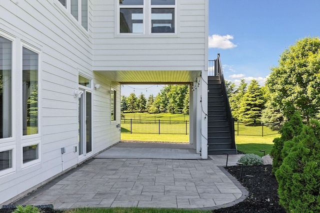 view of exterior entry with a patio