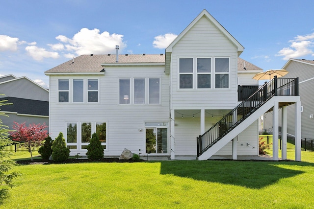 back of house with a lawn