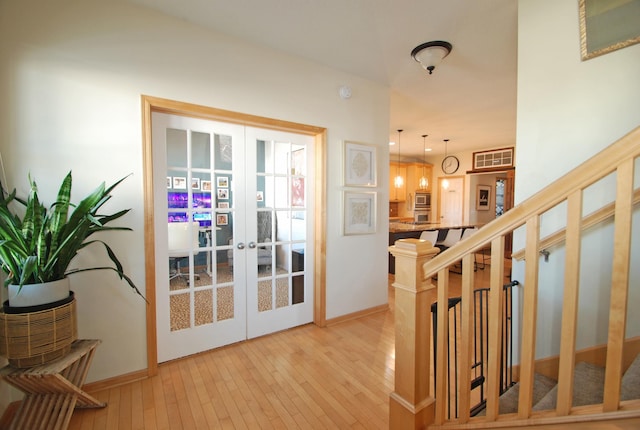 doorway featuring french doors and light wood-type flooring