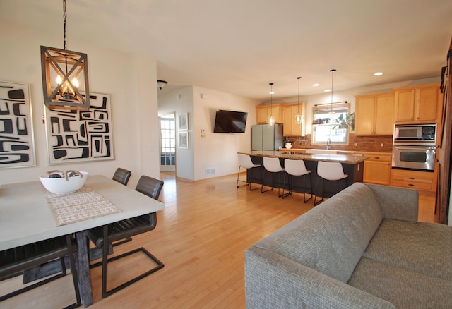 living room featuring sink and light wood-type flooring