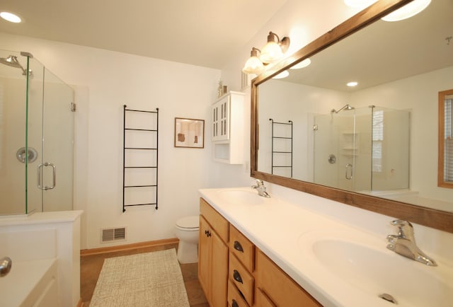 bathroom featuring walk in shower, vanity, and toilet