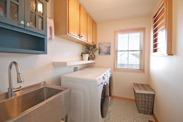 laundry room featuring cabinets, separate washer and dryer, and sink