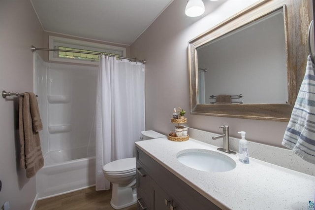 full bathroom featuring vanity, toilet, hardwood / wood-style floors, and shower / tub combo with curtain