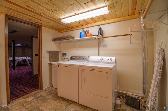 laundry area featuring wood ceiling and independent washer and dryer