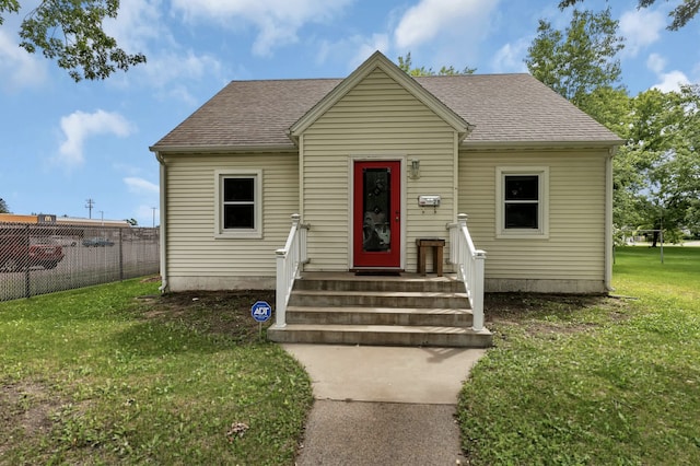 bungalow-style home featuring a front lawn