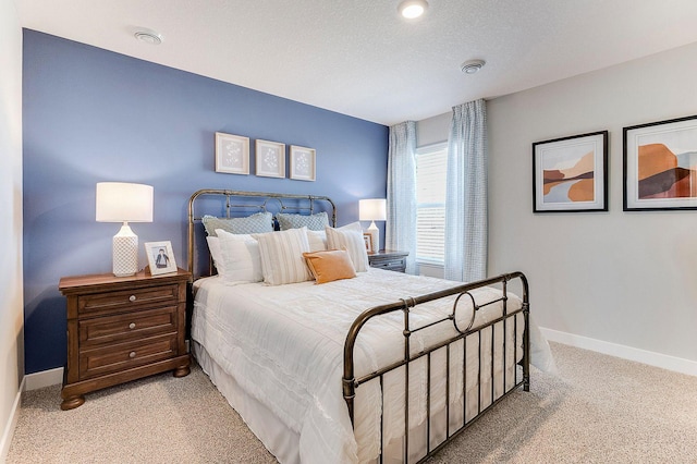 carpeted bedroom featuring a textured ceiling