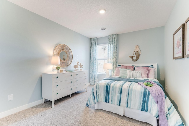 bedroom with a textured ceiling and carpet