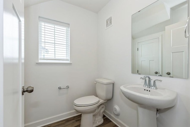 bathroom featuring hardwood / wood-style flooring and toilet