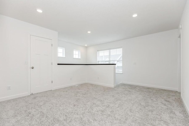 unfurnished room featuring light colored carpet