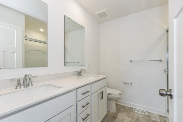 bathroom featuring toilet and vanity