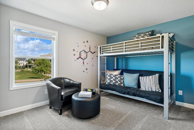 carpeted bedroom featuring multiple windows and a textured ceiling