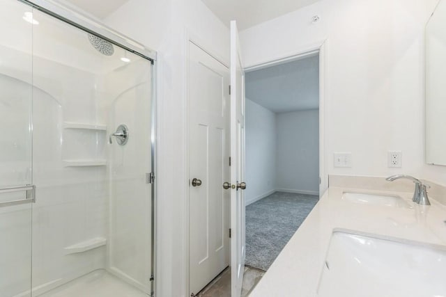 bathroom featuring walk in shower and vanity