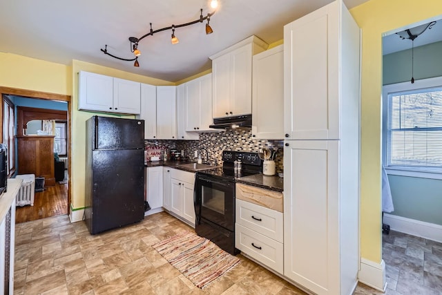 kitchen with white cabinetry, sink, tasteful backsplash, and black appliances