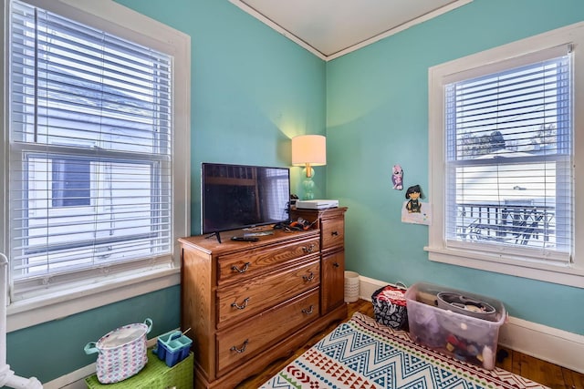 bedroom with wood-type flooring and ornamental molding