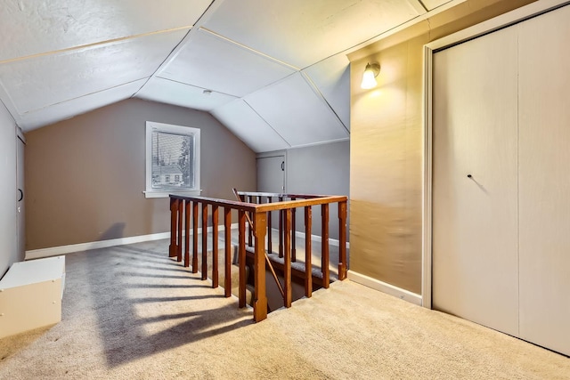 bonus room featuring vaulted ceiling and carpet