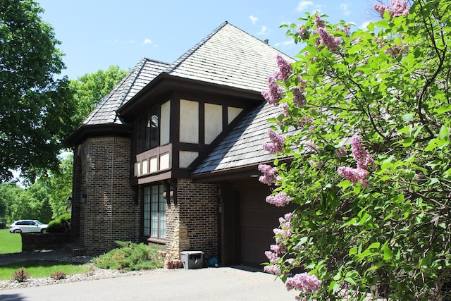 15802 Nursery Dr, Minnetonka, MN 55345 - view of front of home featuring brick siding, stucco siding, and a garage