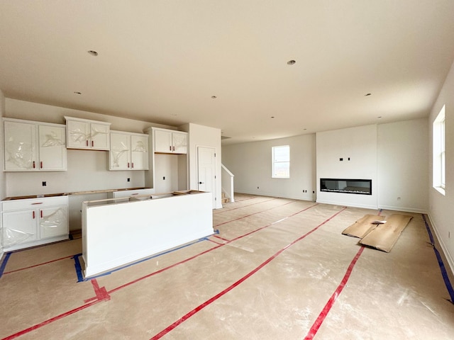 kitchen featuring a kitchen island and white cabinets