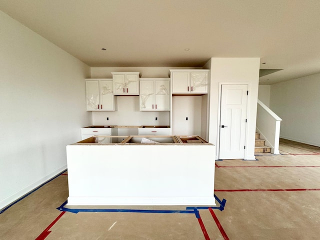 kitchen with white cabinetry and a center island