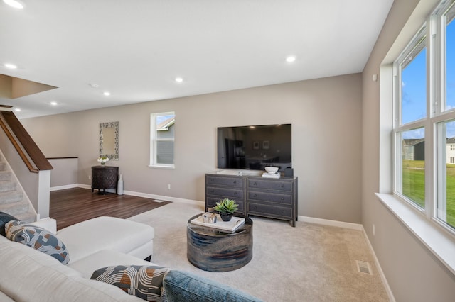 carpeted living room featuring plenty of natural light