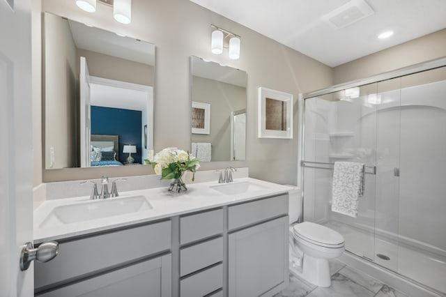 bathroom featuring vanity, toilet, and walk in shower