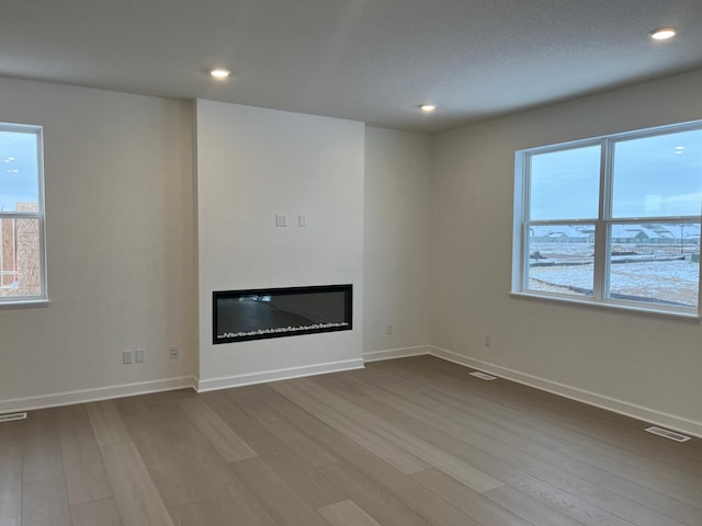 unfurnished living room with wood-type flooring