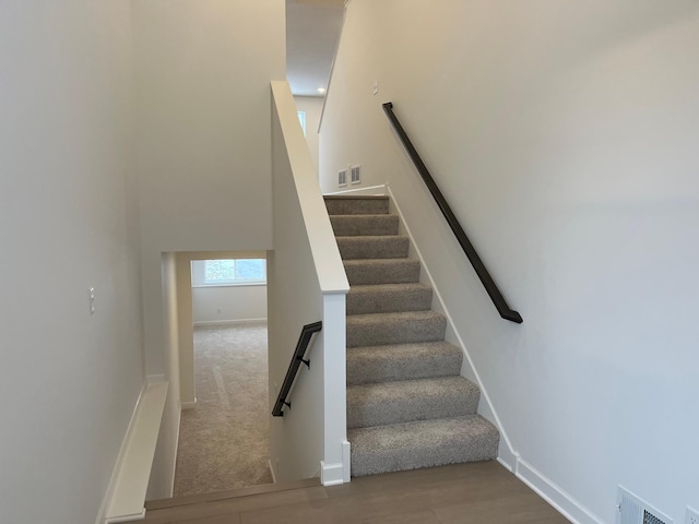 stairway featuring hardwood / wood-style flooring