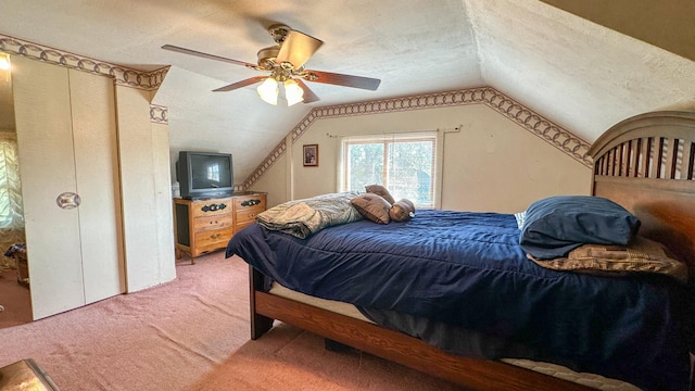 carpeted bedroom featuring ceiling fan, vaulted ceiling, and a textured ceiling