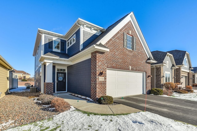 view of front of house featuring a garage and central air condition unit