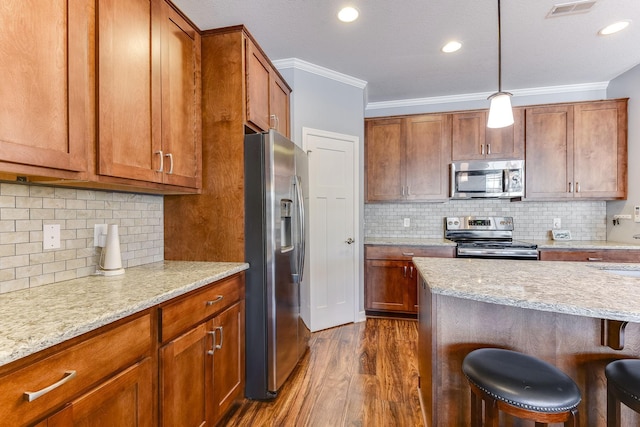 kitchen with a breakfast bar area, crown molding, appliances with stainless steel finishes, dark hardwood / wood-style floors, and backsplash