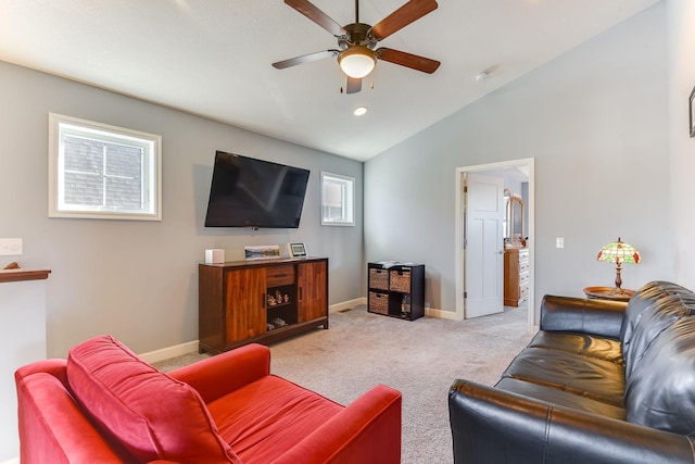 carpeted living room featuring ceiling fan and vaulted ceiling