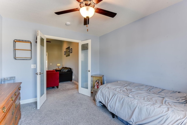 carpeted bedroom with french doors and ceiling fan