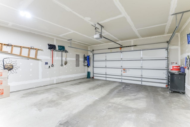 garage featuring a garage door opener and electric panel