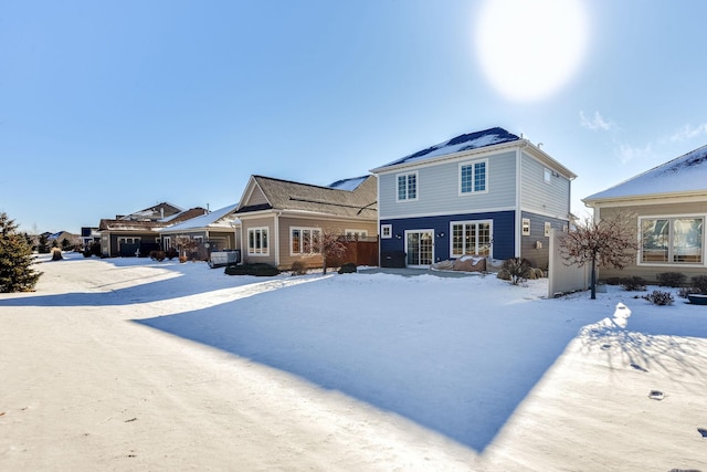 view of snow covered back of property