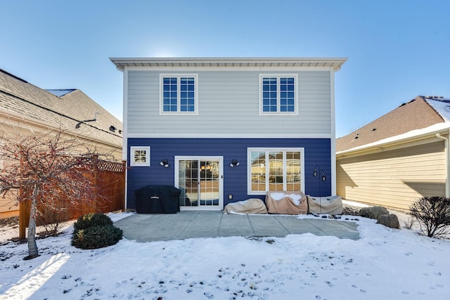 view of snow covered rear of property