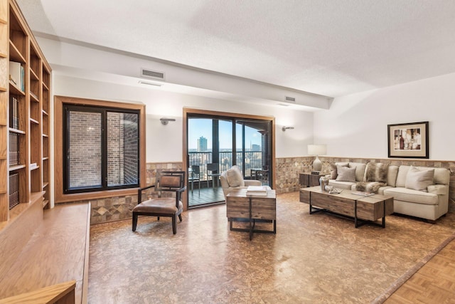 living room featuring parquet flooring and a textured ceiling