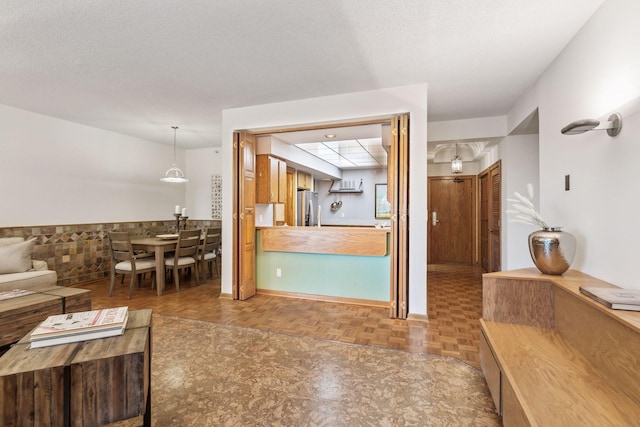 living room featuring parquet flooring and a textured ceiling