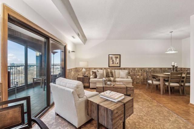 living room featuring parquet flooring and a textured ceiling