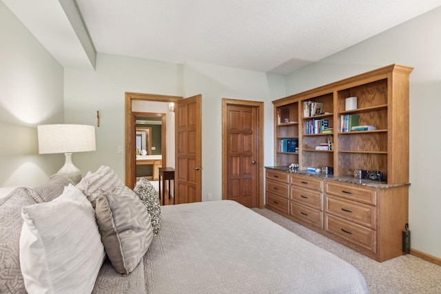 carpeted bedroom featuring connected bathroom