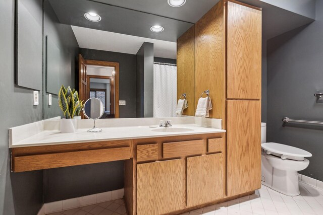 bathroom featuring vanity, toilet, and tile patterned floors