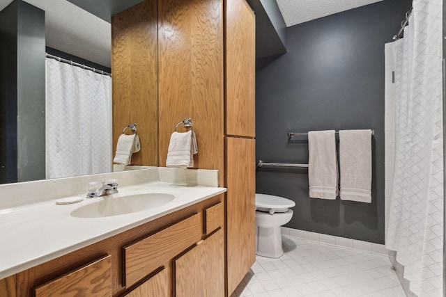 bathroom with toilet, a textured ceiling, tile patterned floors, and vanity